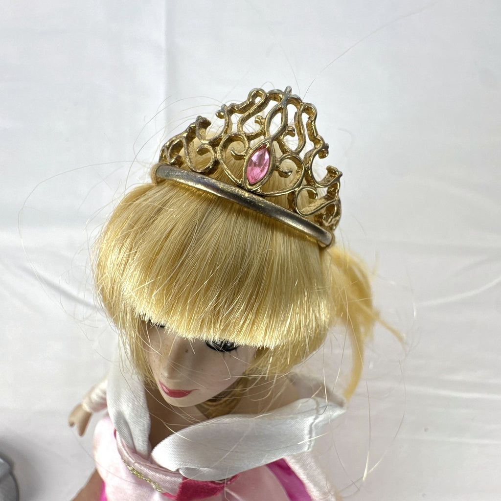 The Brass Key Disney Princess Aurora 12-inch porcelain doll wearing a pink ballgown and golden tiara