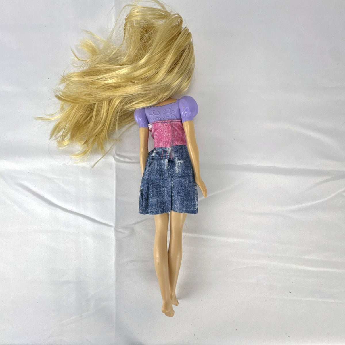 Mattel Disney Princess Rapunzel 11-inch fashion doll with long blonde hair and tiered skirt.