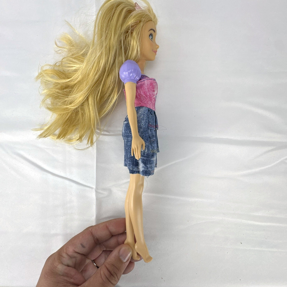 Mattel Disney Princess Rapunzel 11-inch fashion doll with long blonde hair and tiered skirt.
