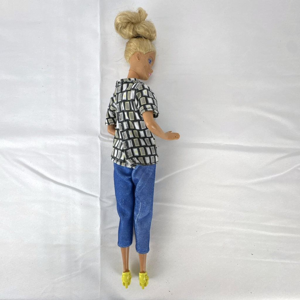 Vintage Mattel Barbie 12-inch doll with blonde hair bun updo, geometric top, blue cropped pants, and yellow platform heels.