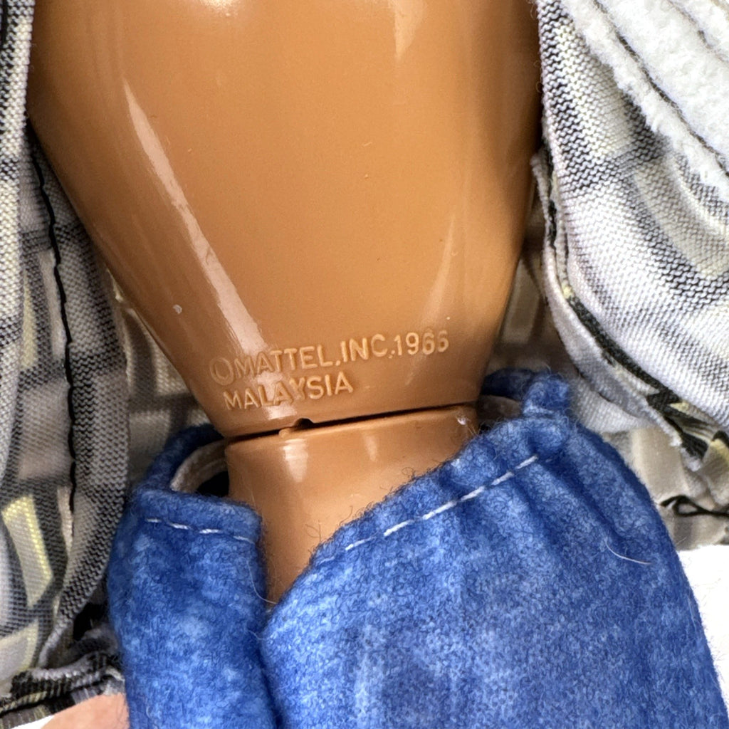 Vintage Mattel Barbie 12-inch doll with blonde hair bun updo, geometric top, blue cropped pants, and yellow platform heels.