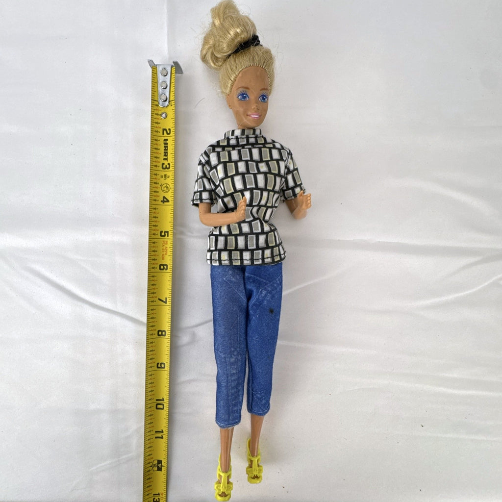 Vintage Mattel Barbie 12-inch doll with blonde hair bun updo, geometric top, blue cropped pants, and yellow platform heels.