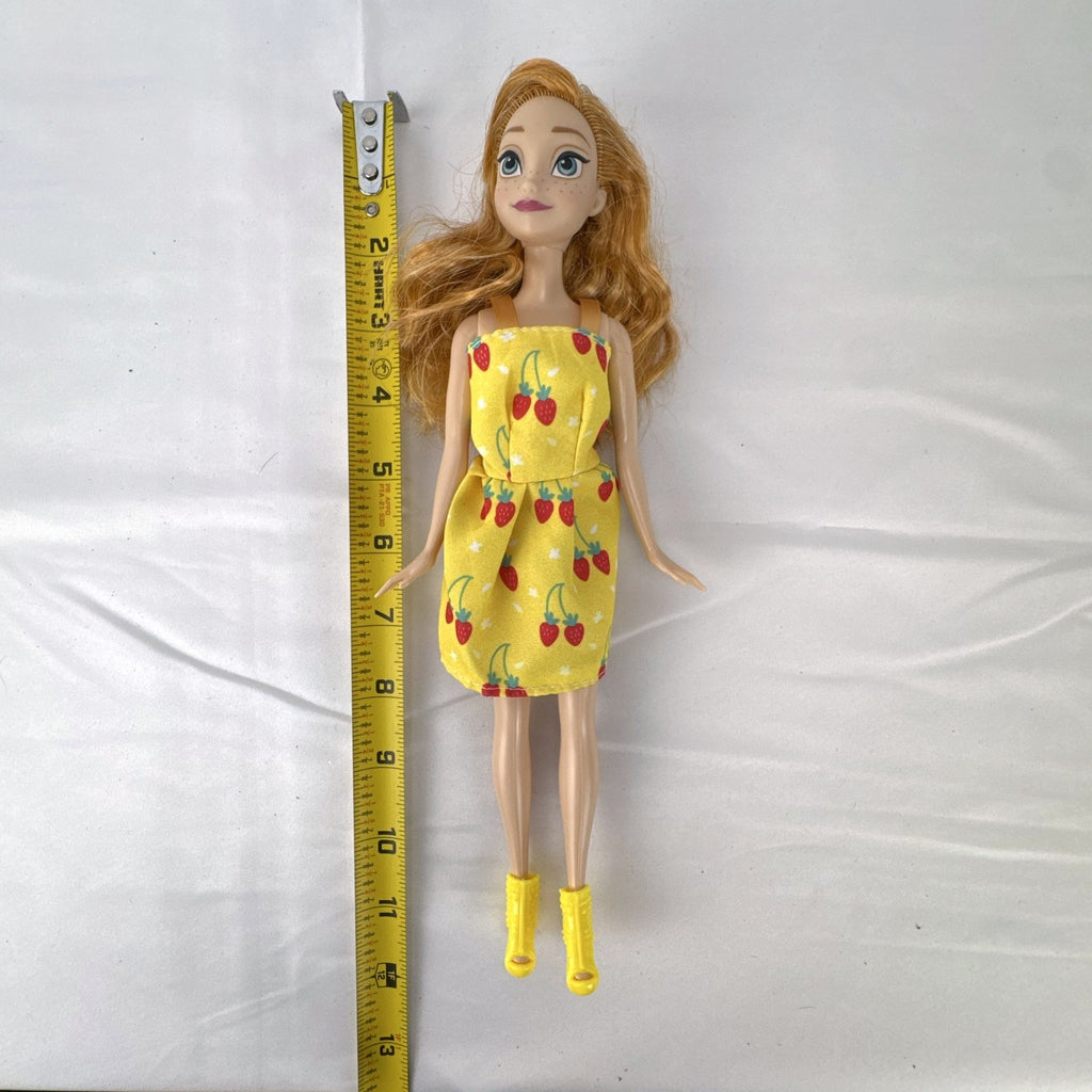 Mattel Disney Frozen Princess Anna 11-inch fashion doll wearing yellow strawberry dress and ankle booties