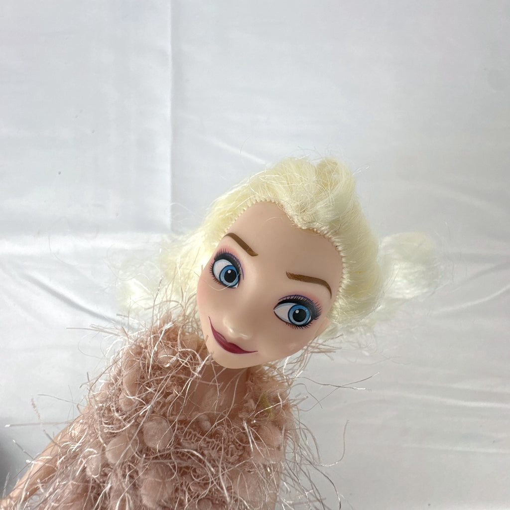 Disney Frozen Elsa 11-inch fashion doll wearing a fuzzy pink knit dress