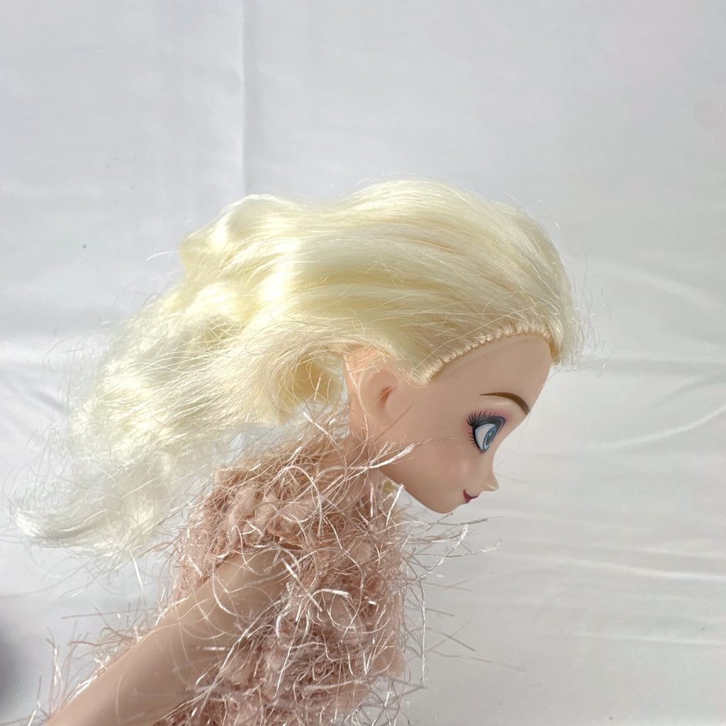 Disney Frozen Elsa 11-inch fashion doll wearing a fuzzy pink knit dress