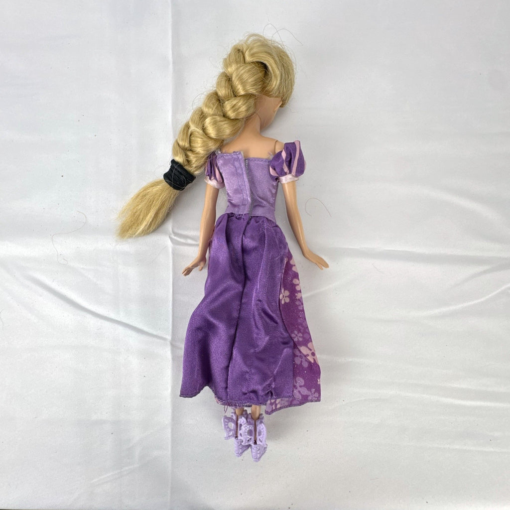 Mattel Disney Princess Rapunzel 11-inch doll wearing purple floral dress and shoes with braided blonde hair