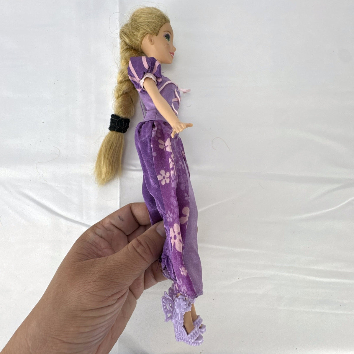 Mattel Disney Princess Rapunzel 11-inch doll wearing purple floral dress and shoes with braided blonde hair