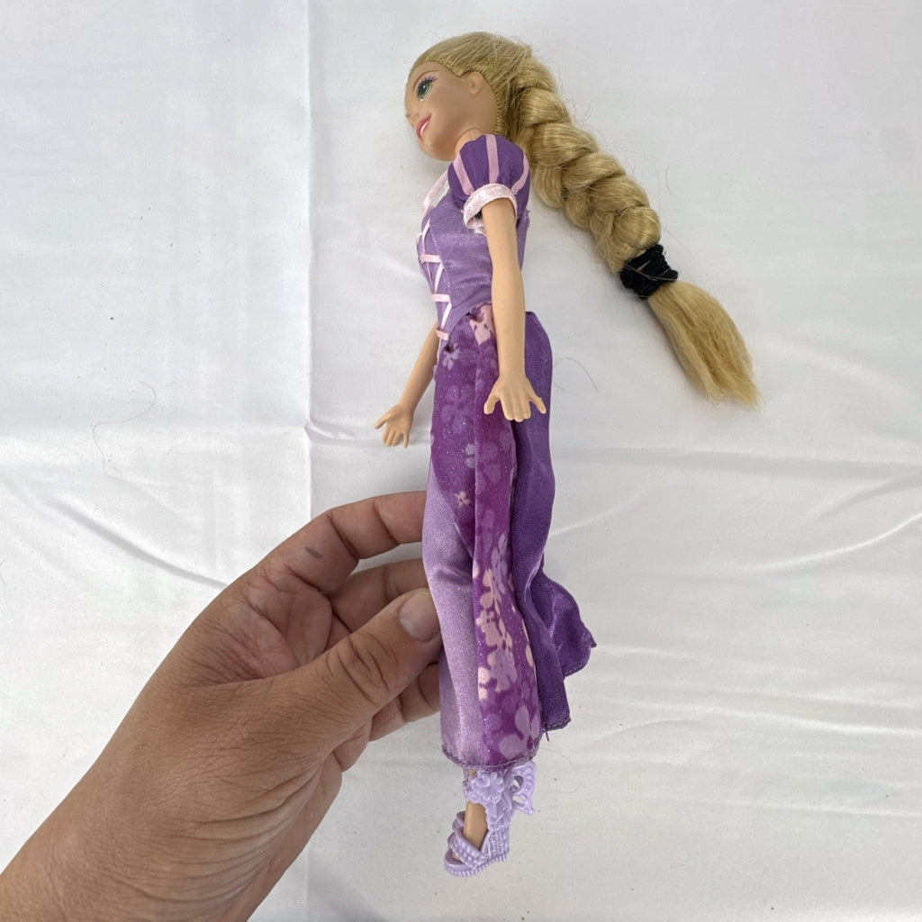 Mattel Disney Princess Rapunzel 11-inch doll wearing purple floral dress and shoes with braided blonde hair