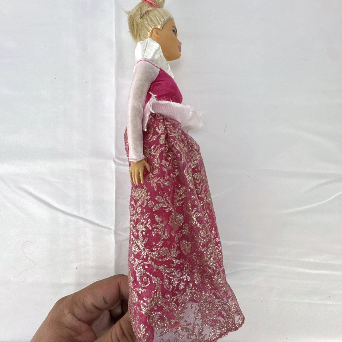 12-inch Mattel Barbie fashion doll wearing a pink Disney Princess Aurora Sleeping Beauty dress with blonde hair in a topknot