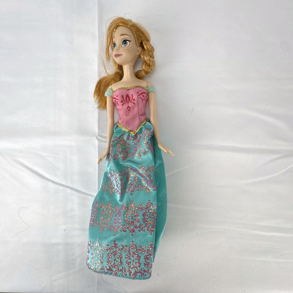 Mattel Disney Frozen 11-inch Princess Anna doll in pink and teal glitter dress with braided hair