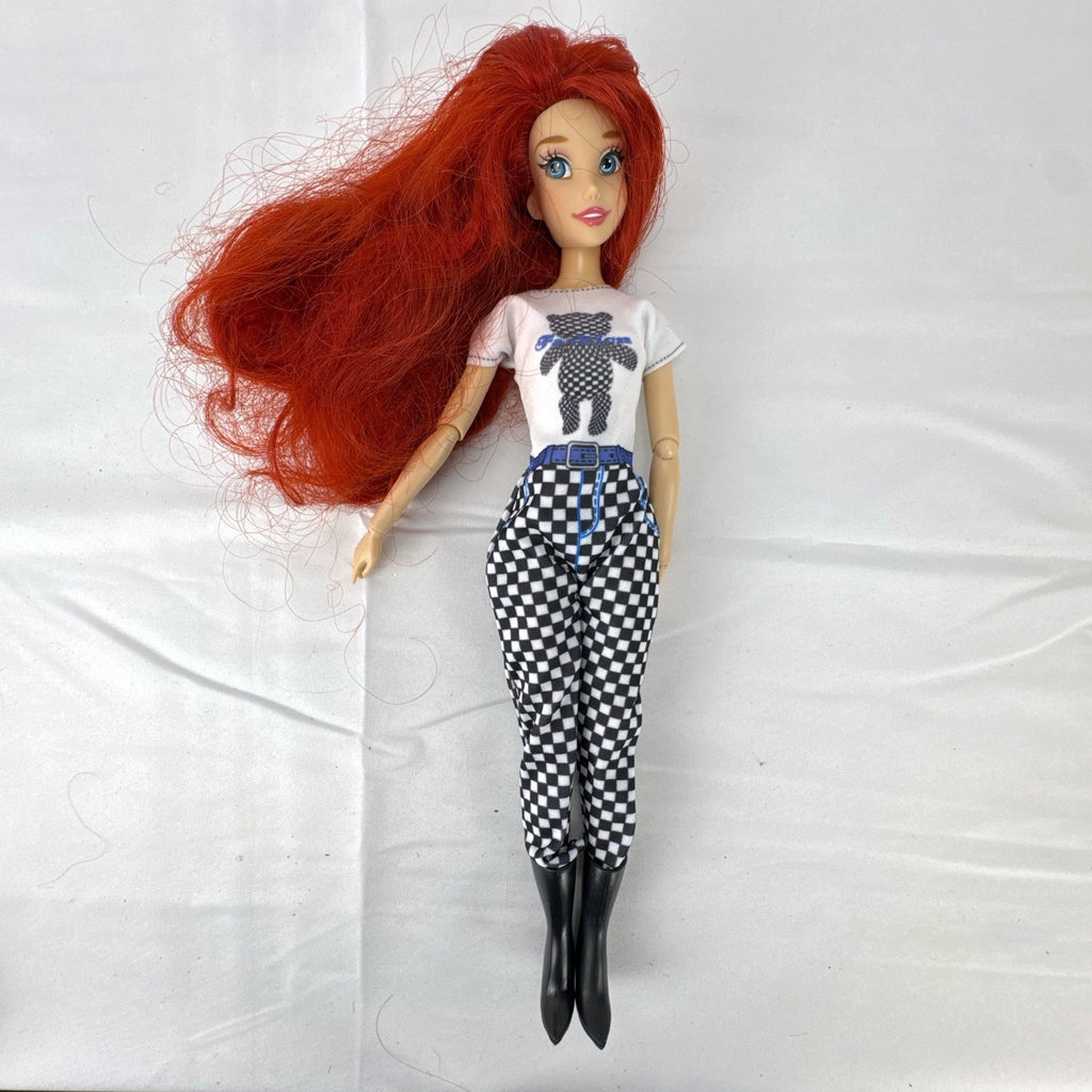 Articulated 11-inch Disney Ariel fashion doll with red hair in casual checkered pants and graphic t-shirt