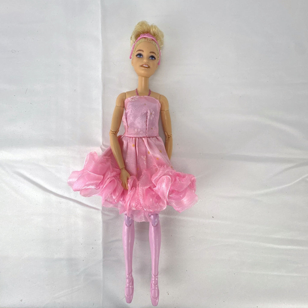 Mattel Barbie 12-inch articulated ballerina doll wearing a pink ruffled tutu dress with blonde bun hair.