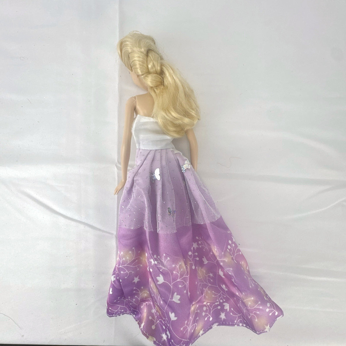 Mattel Disney Frozen Elsa 11-inch fashion doll with blonde braid in purple floral dress and heels