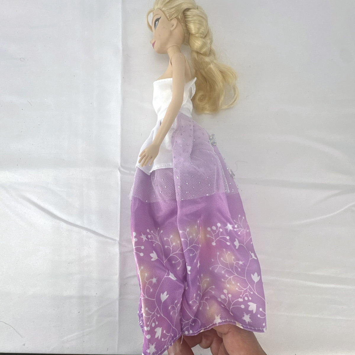 Mattel Disney Frozen Elsa 11-inch fashion doll with blonde braid in purple floral dress and heels