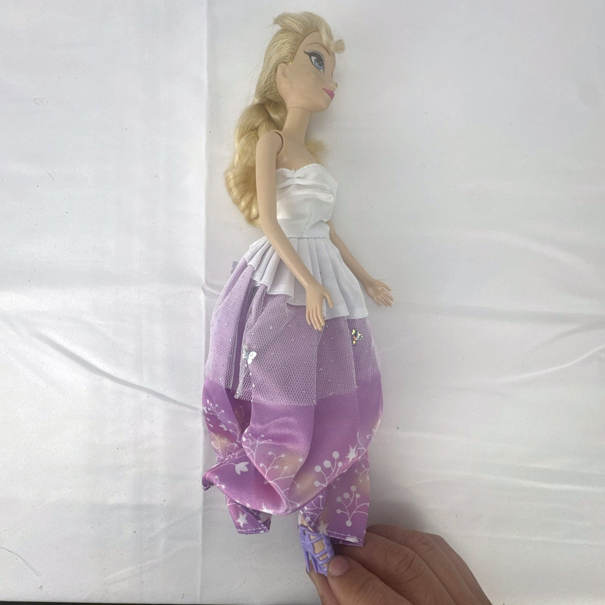 Mattel Disney Frozen Elsa 11-inch fashion doll with blonde braid in purple floral dress and heels