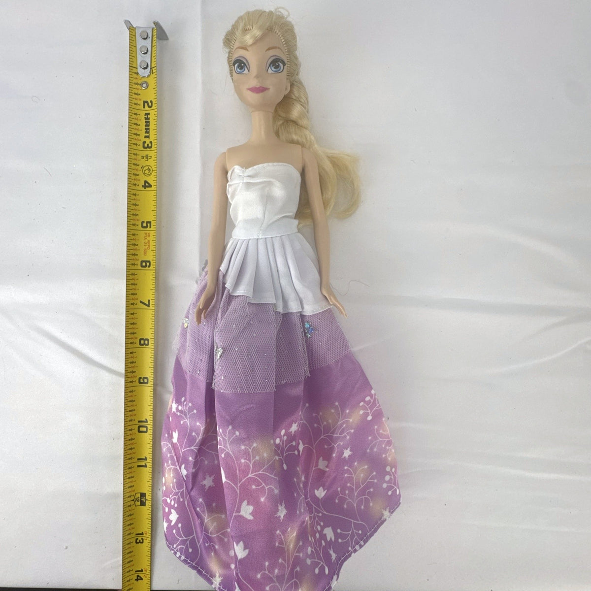 Mattel Disney Frozen Elsa 11-inch fashion doll with blonde braid in purple floral dress and heels