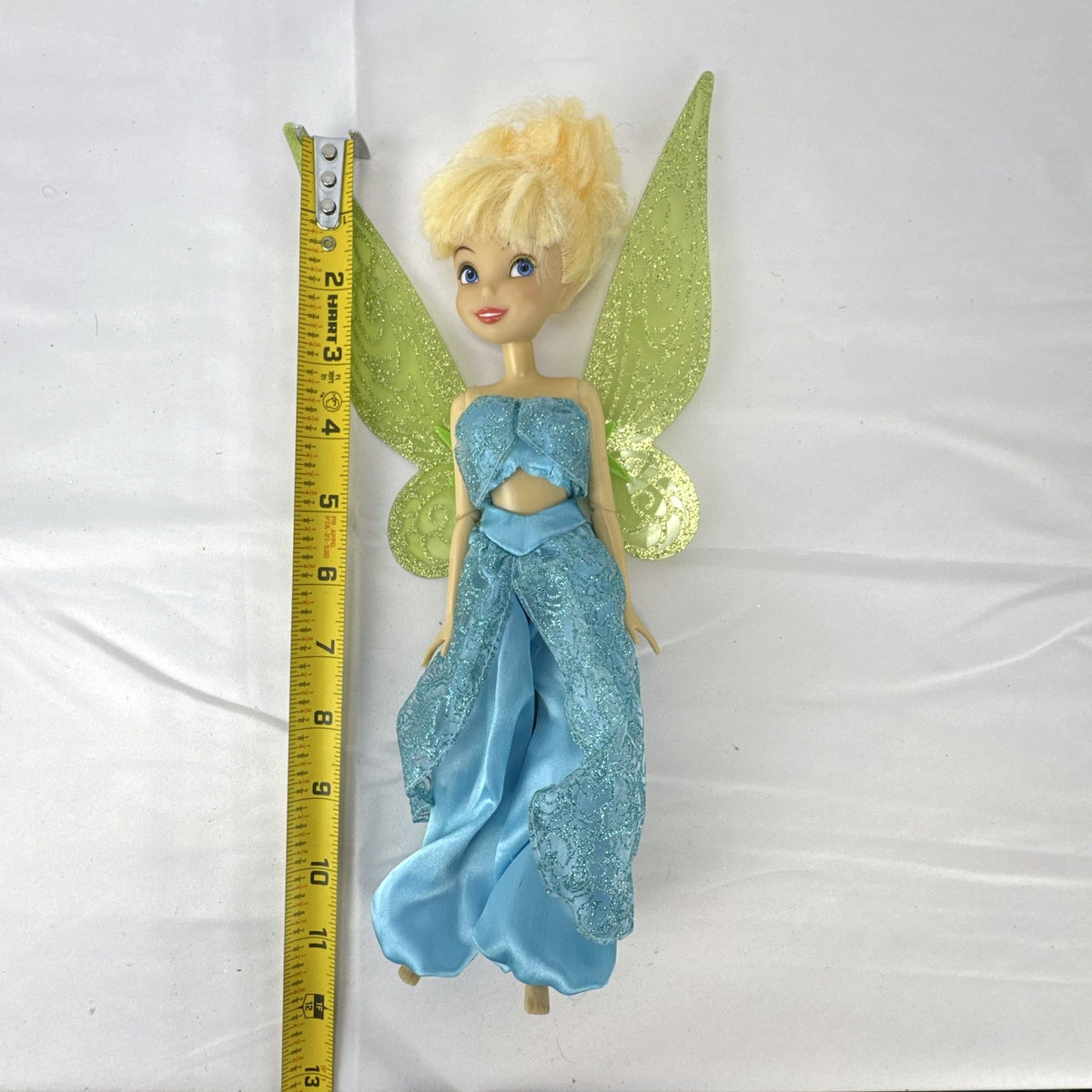 Disney Fairies Tinker Bell 10-inch doll wearing shimmering blue outfit with translucent green glitter wings