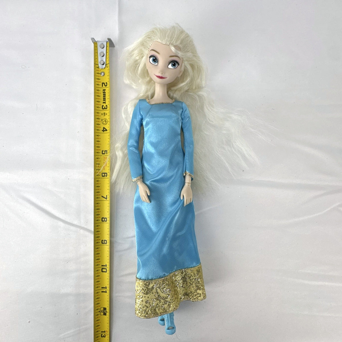 Disney Frozen Elsa 11.5-inch articulated doll wearing blue glitter gown and matching shoes