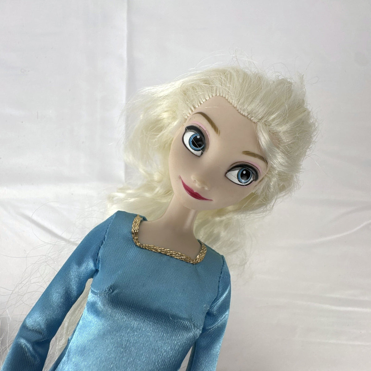 Disney Frozen Elsa 11.5-inch articulated doll wearing blue glitter gown and matching shoes