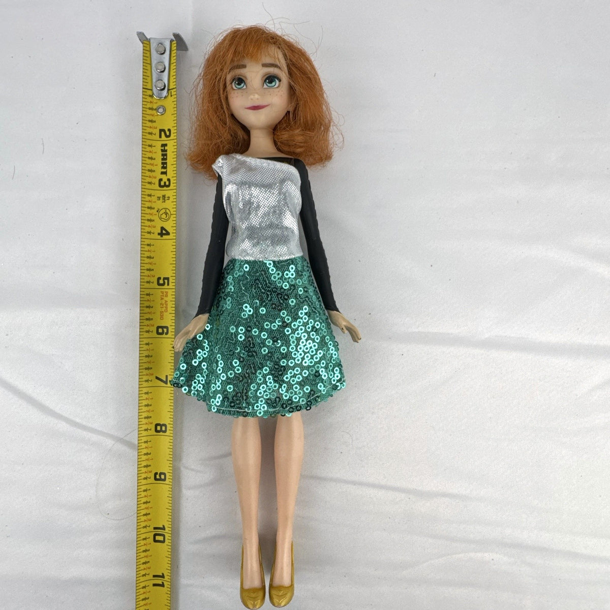 Hasbro Disney Frozen Style Series 11-inch Anna doll wearing a sequin dress and gold heels