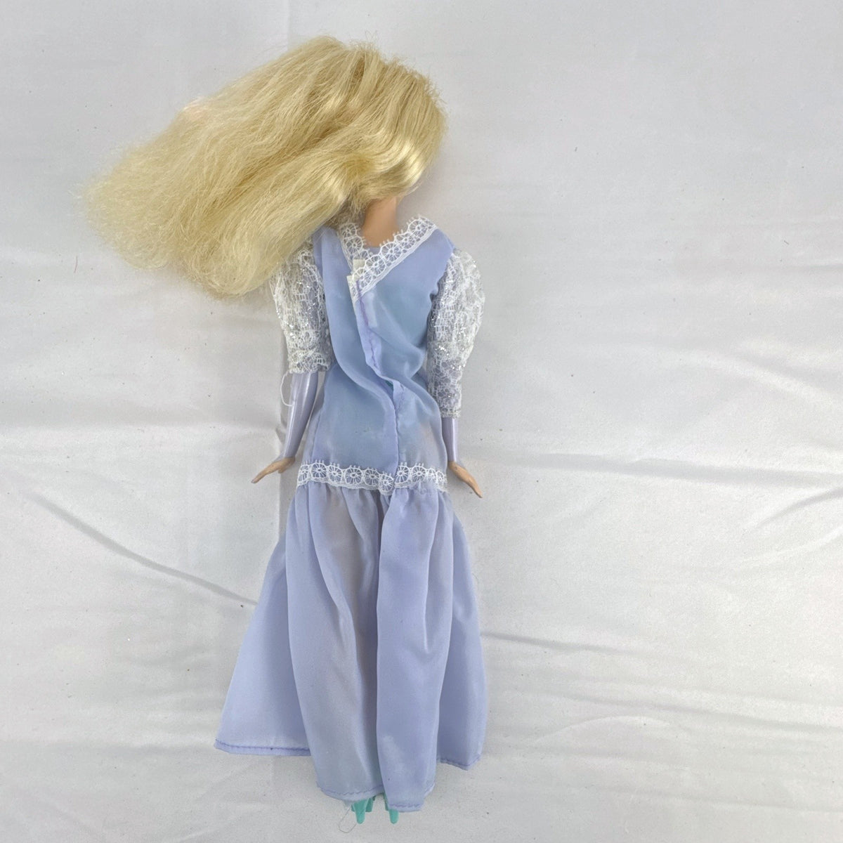 Mattel Disney Frozen Elsa 11-inch fashion doll wearing a purple lace gown and teal shoes.