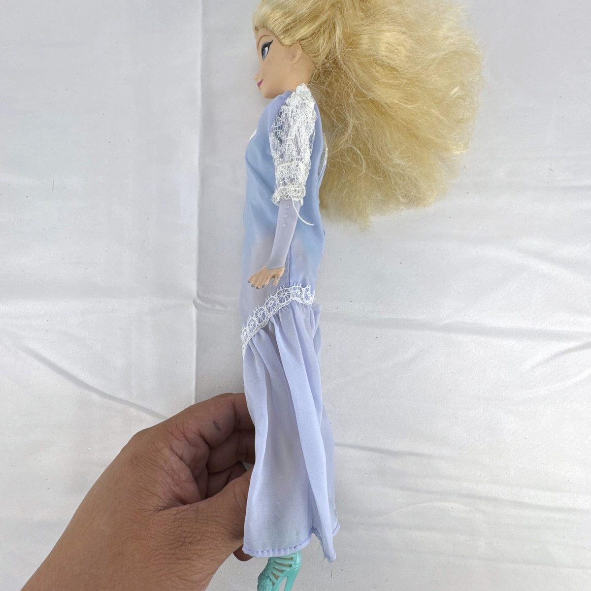 Mattel Disney Frozen Elsa 11-inch fashion doll wearing a purple lace gown and teal shoes.
