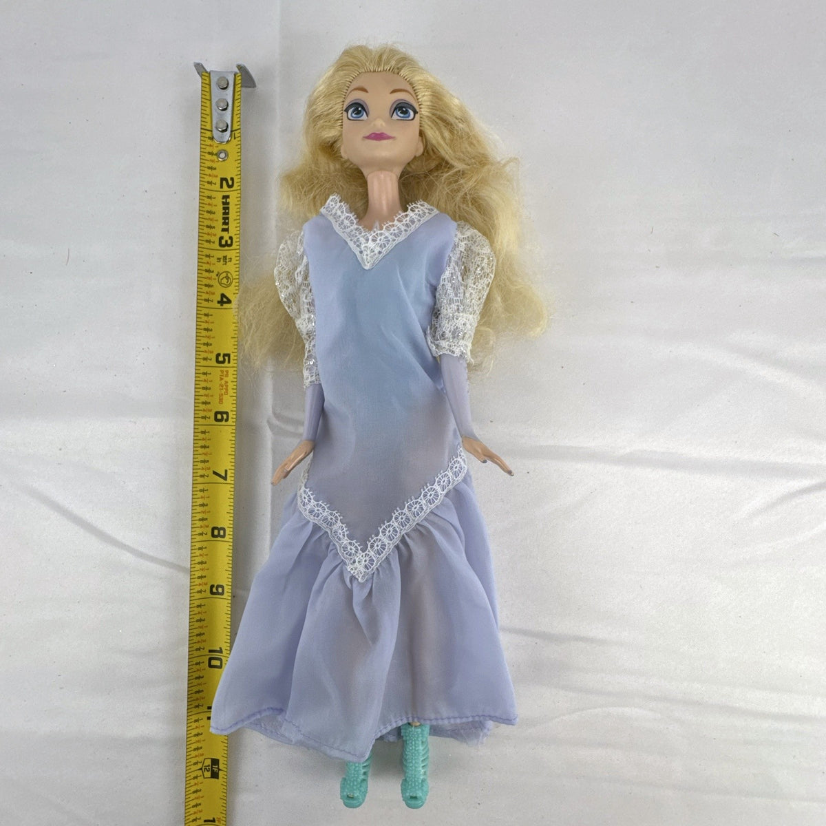 Mattel Disney Frozen Elsa 11-inch fashion doll wearing a purple lace gown and teal shoes.