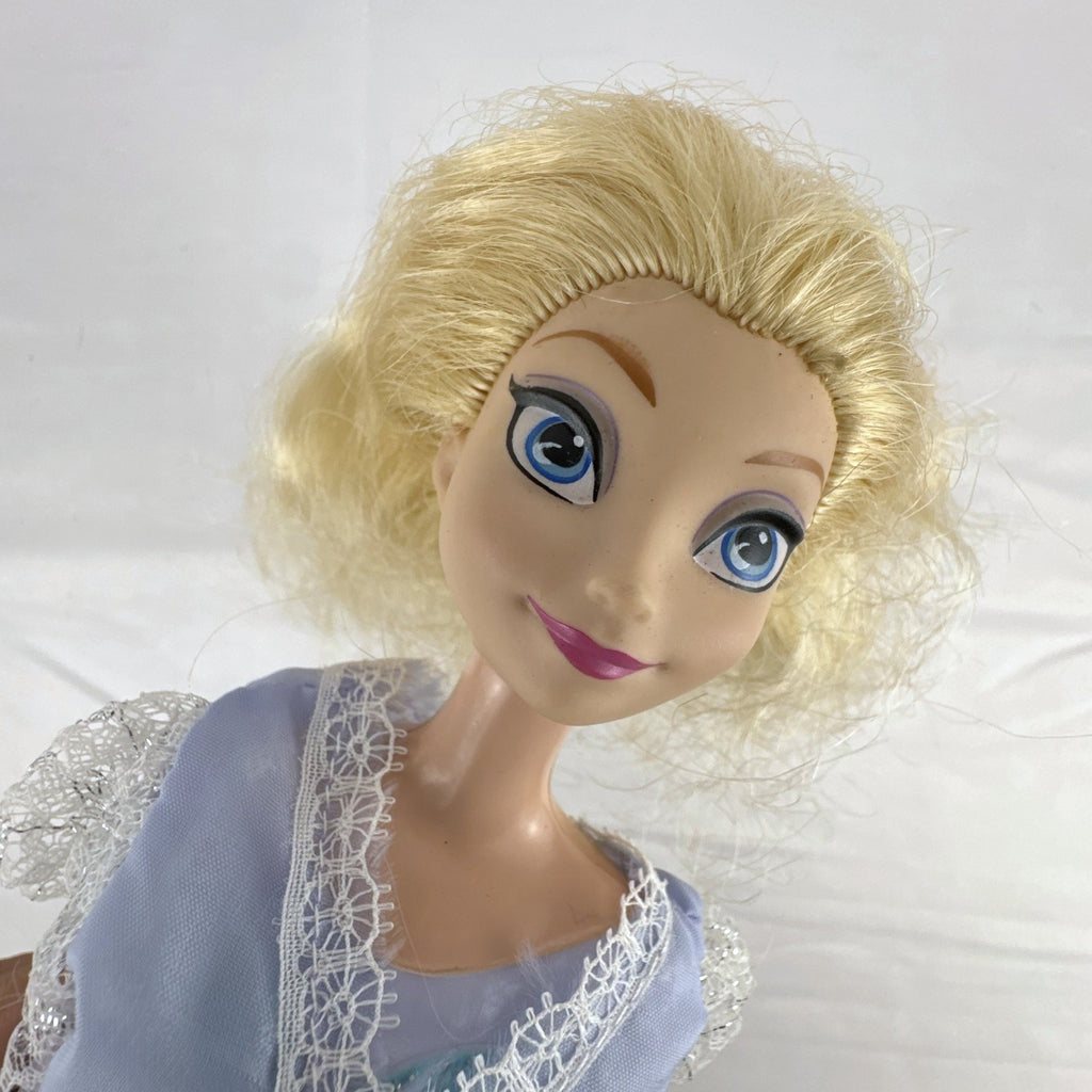 Mattel Disney Frozen Elsa 11-inch fashion doll wearing a purple lace gown and teal shoes.