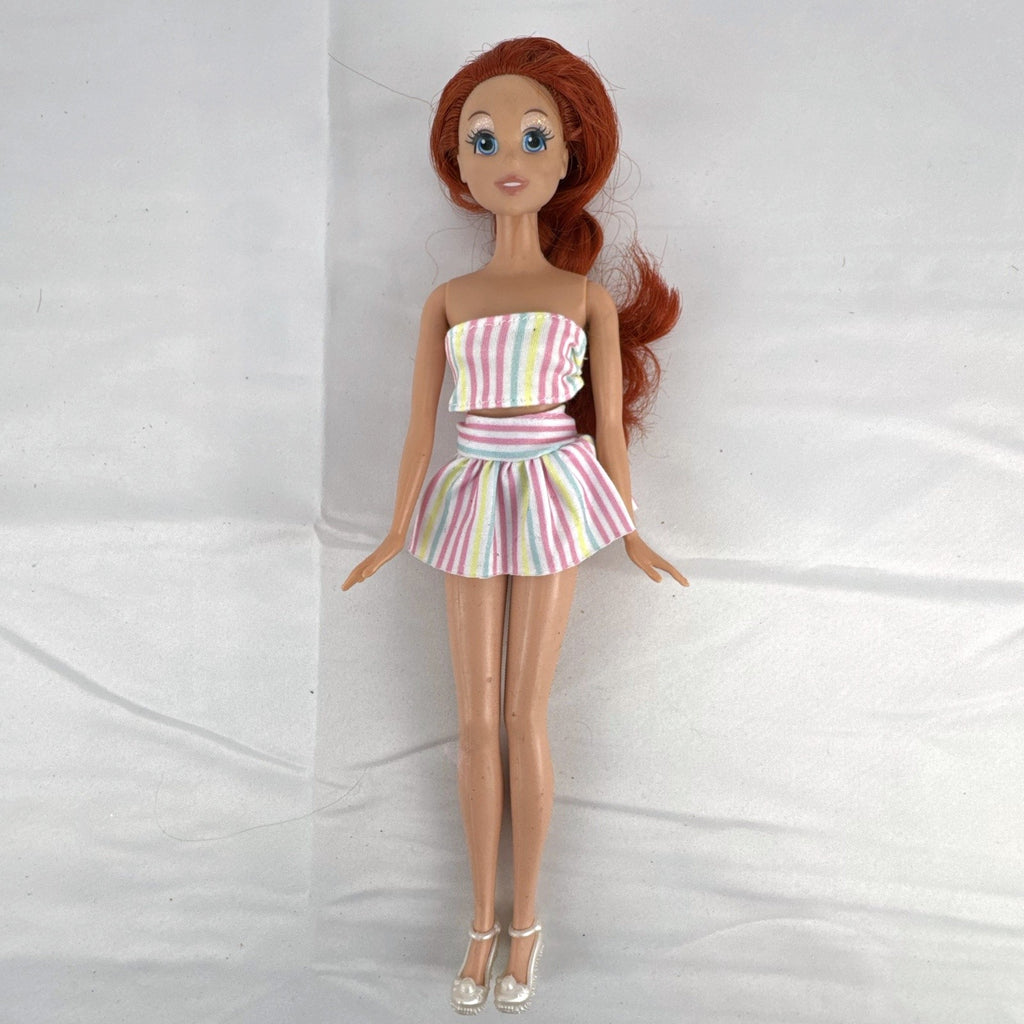 Mattel 2005 Disney Princess Ariel 11-inch fashion doll with red hair in a pastel striped outfit and pearlized heels.