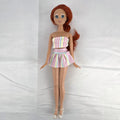 Mattel 2005 Disney Princess Ariel 11-inch fashion doll with red hair in a pastel striped outfit and pearlized heels.