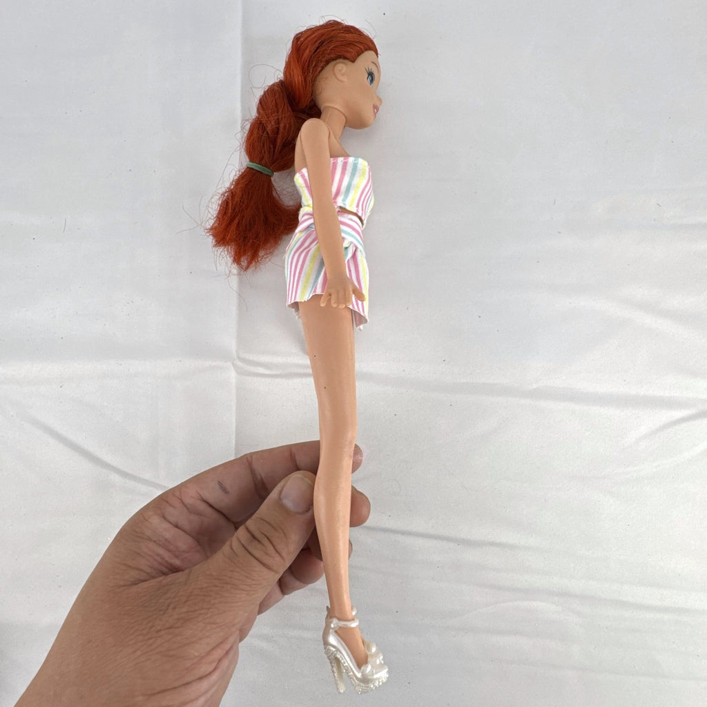 Mattel 2005 Disney Princess Ariel 11-inch fashion doll with red hair in a pastel striped outfit and pearlized heels.