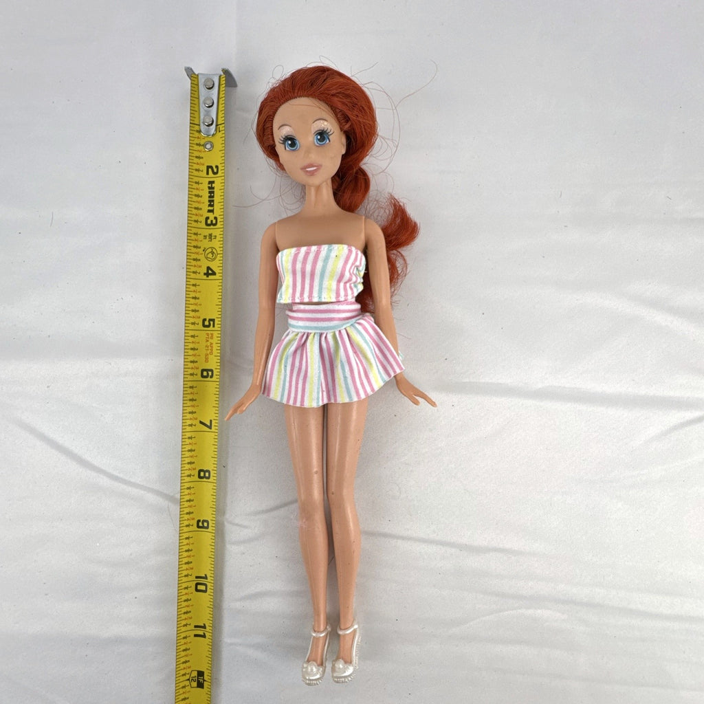 Mattel 2005 Disney Princess Ariel 11-inch fashion doll with red hair in a pastel striped outfit and pearlized heels.