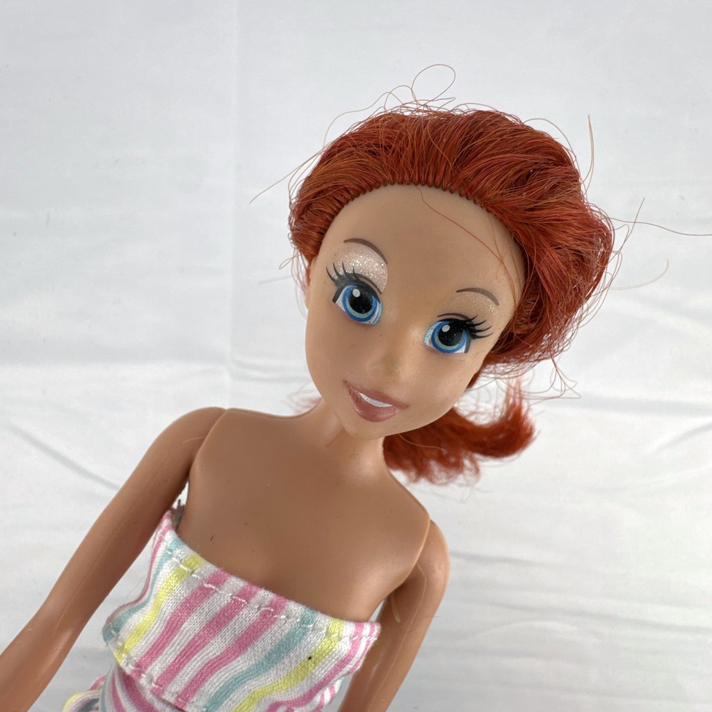 Mattel 2005 Disney Princess Ariel 11-inch fashion doll with red hair in a pastel striped outfit and pearlized heels.
