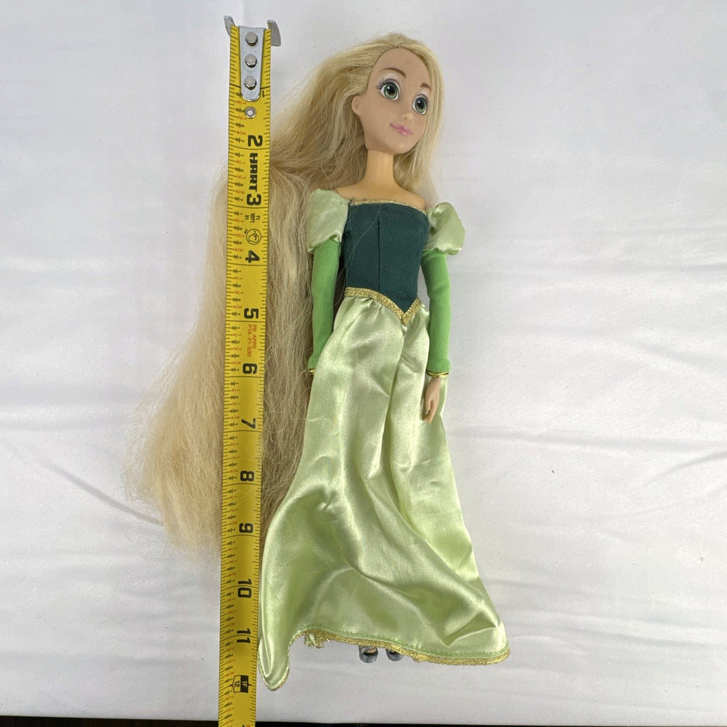 Disney Princess Rapunzel 12-inch fashion doll wearing a two-tone green gown with gold trim and grey shoes.