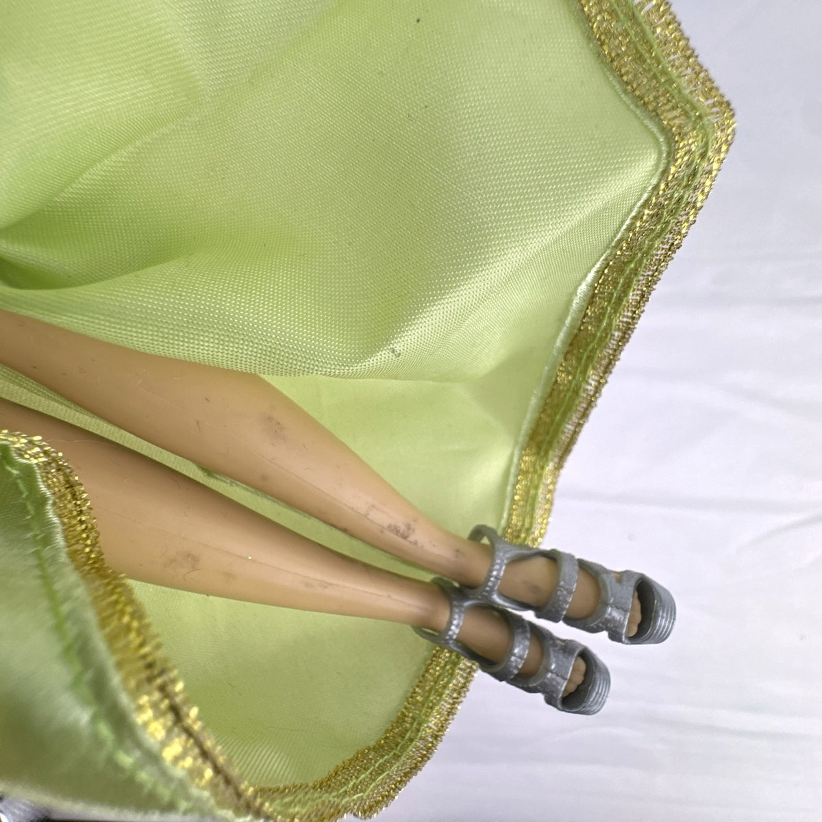 Disney Princess Rapunzel 12-inch fashion doll wearing a two-tone green gown with gold trim and grey shoes.