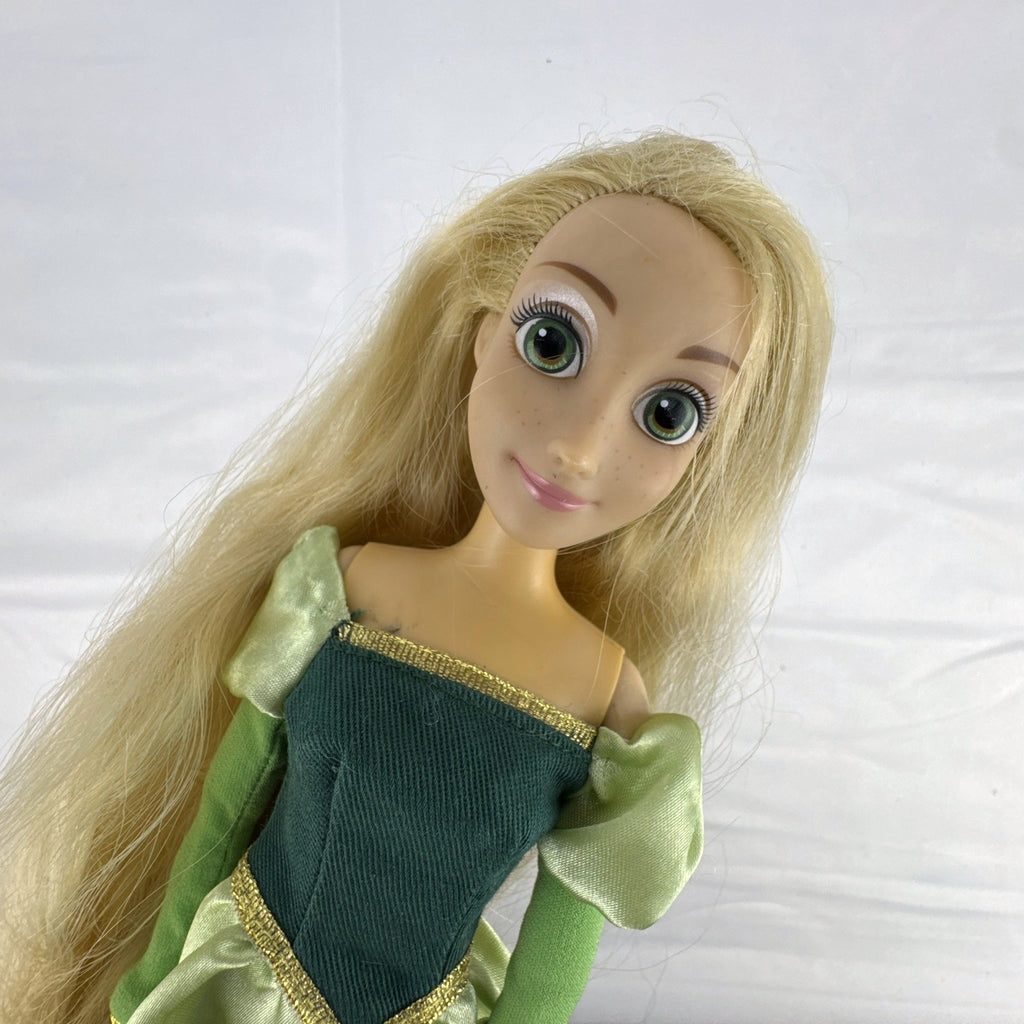 Disney Princess Rapunzel 12-inch fashion doll wearing a two-tone green gown with gold trim and grey shoes.