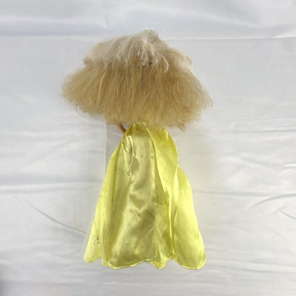 Vintage Mattel Barbie doll wearing yellow butterfly pattern gown with pink earrings