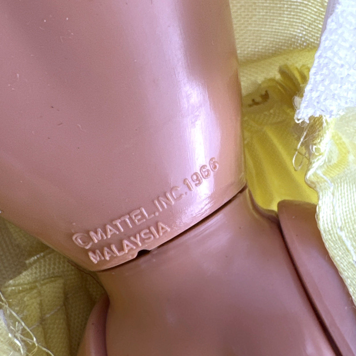 Vintage Mattel Barbie doll wearing yellow butterfly pattern gown with pink earrings