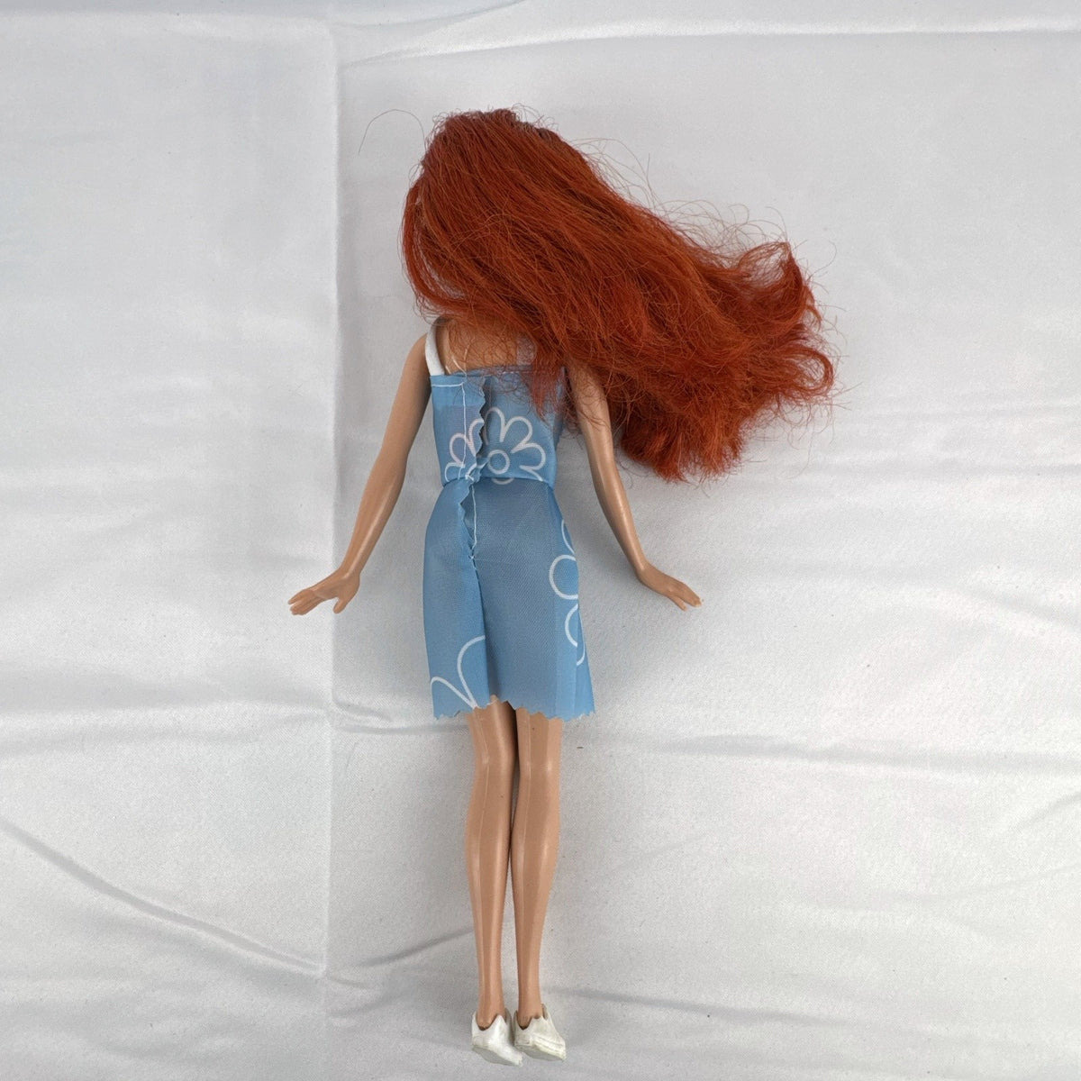 Disney Princess Ariel 11-inch fashion doll with red hair in a blue floral dress and white sneakers