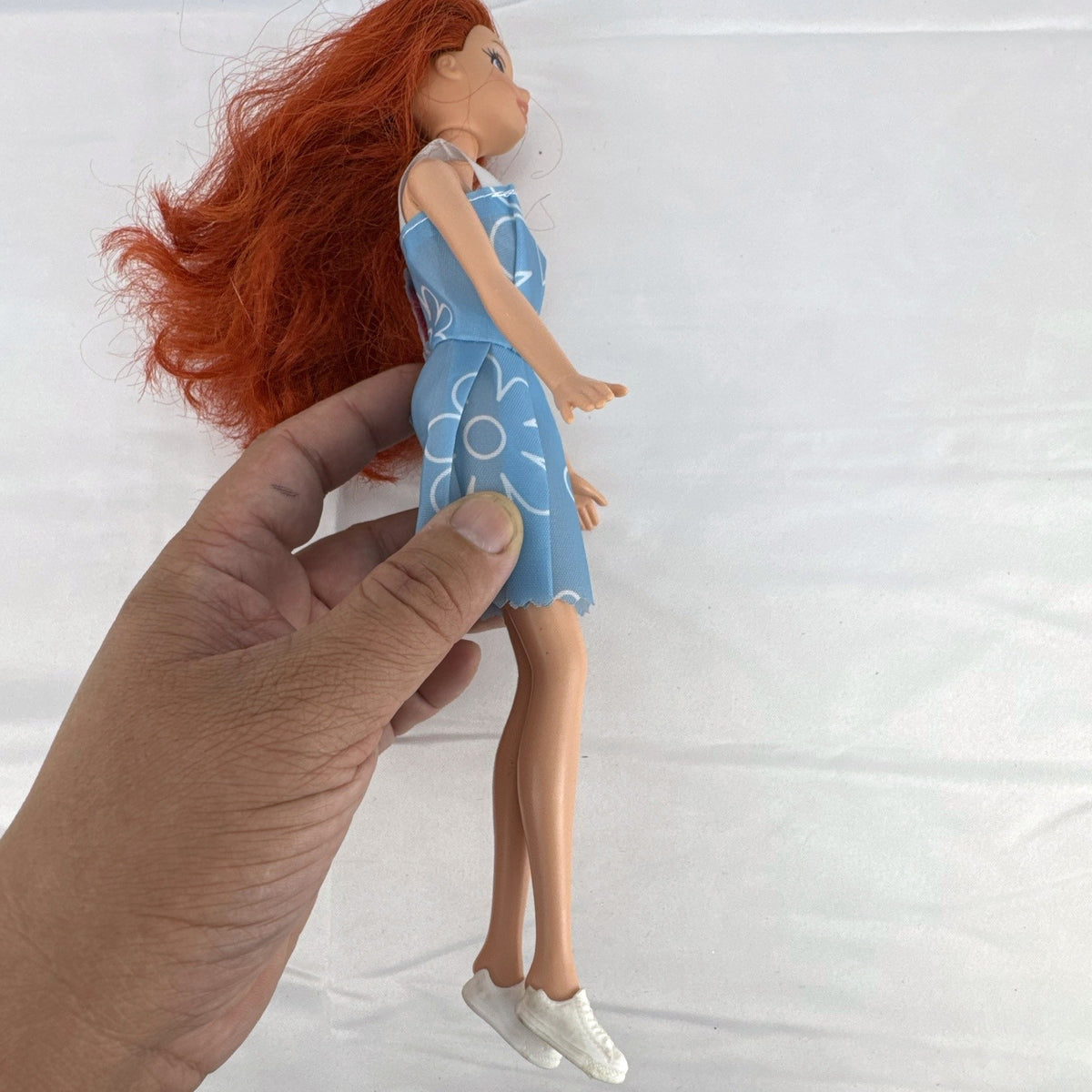 Disney Princess Ariel 11-inch fashion doll with red hair in a blue floral dress and white sneakers