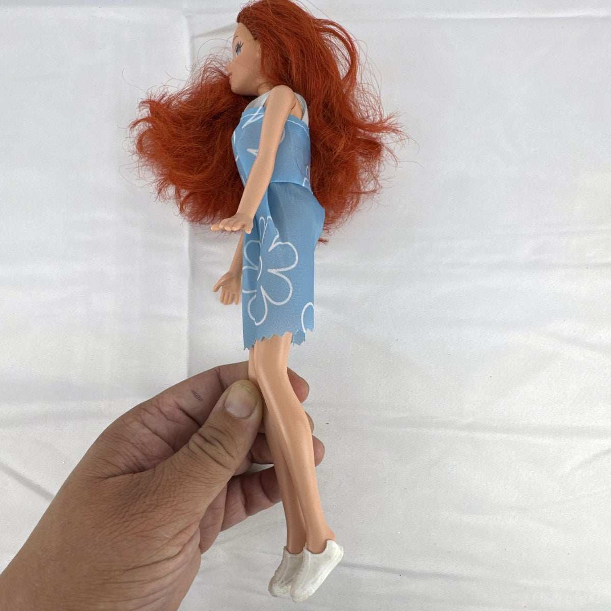 Disney Princess Ariel 11-inch fashion doll with red hair in a blue floral dress and white sneakers