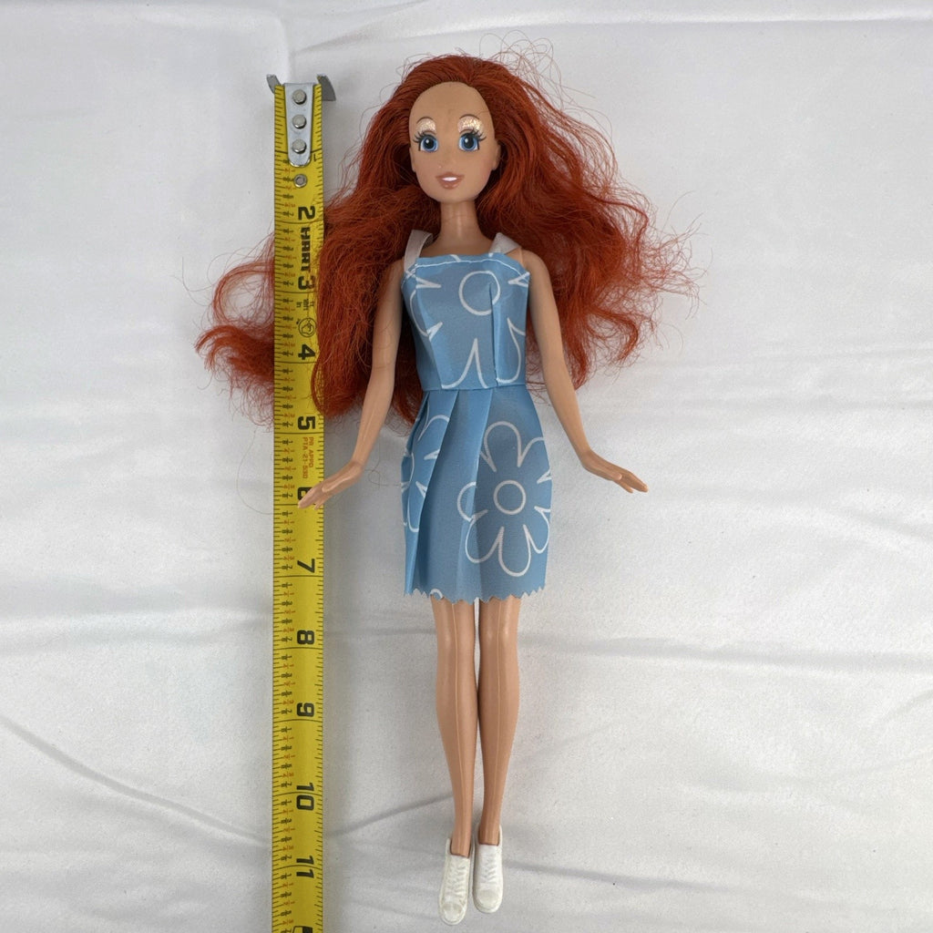 Disney Princess Ariel 11-inch fashion doll with red hair in a blue floral dress and white sneakers