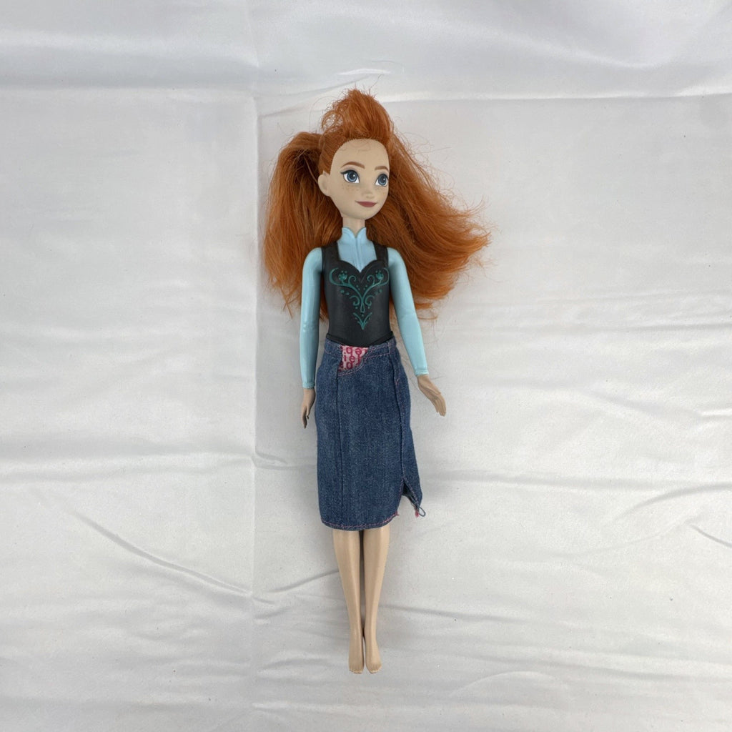 Mattel Disney Frozen 11-inch Princess Anna doll with red hair, molded bodice, and denim skirt.