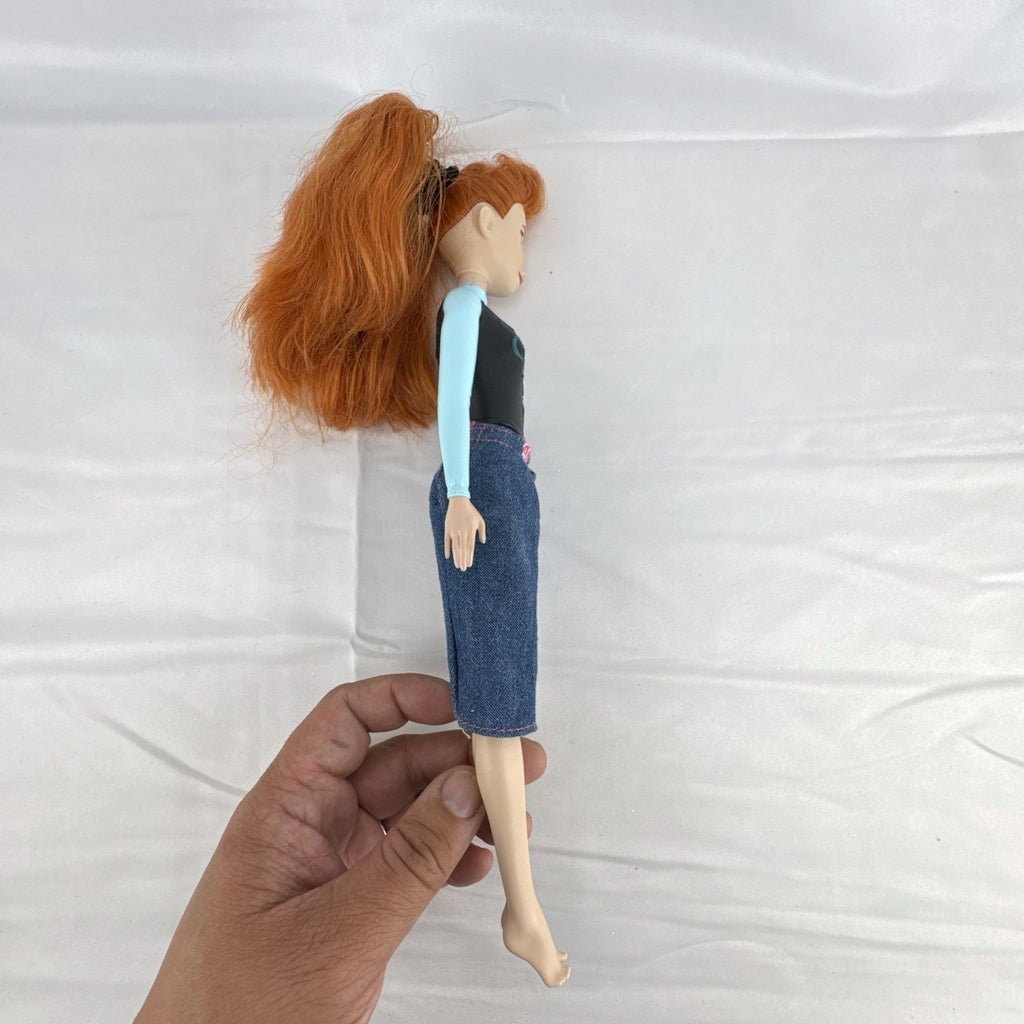 Mattel Disney Frozen 11-inch Princess Anna doll with red hair, molded bodice, and denim skirt.