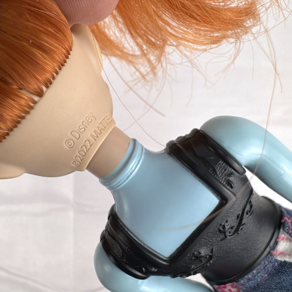 Mattel Disney Frozen 11-inch Princess Anna doll with red hair, molded bodice, and denim skirt.