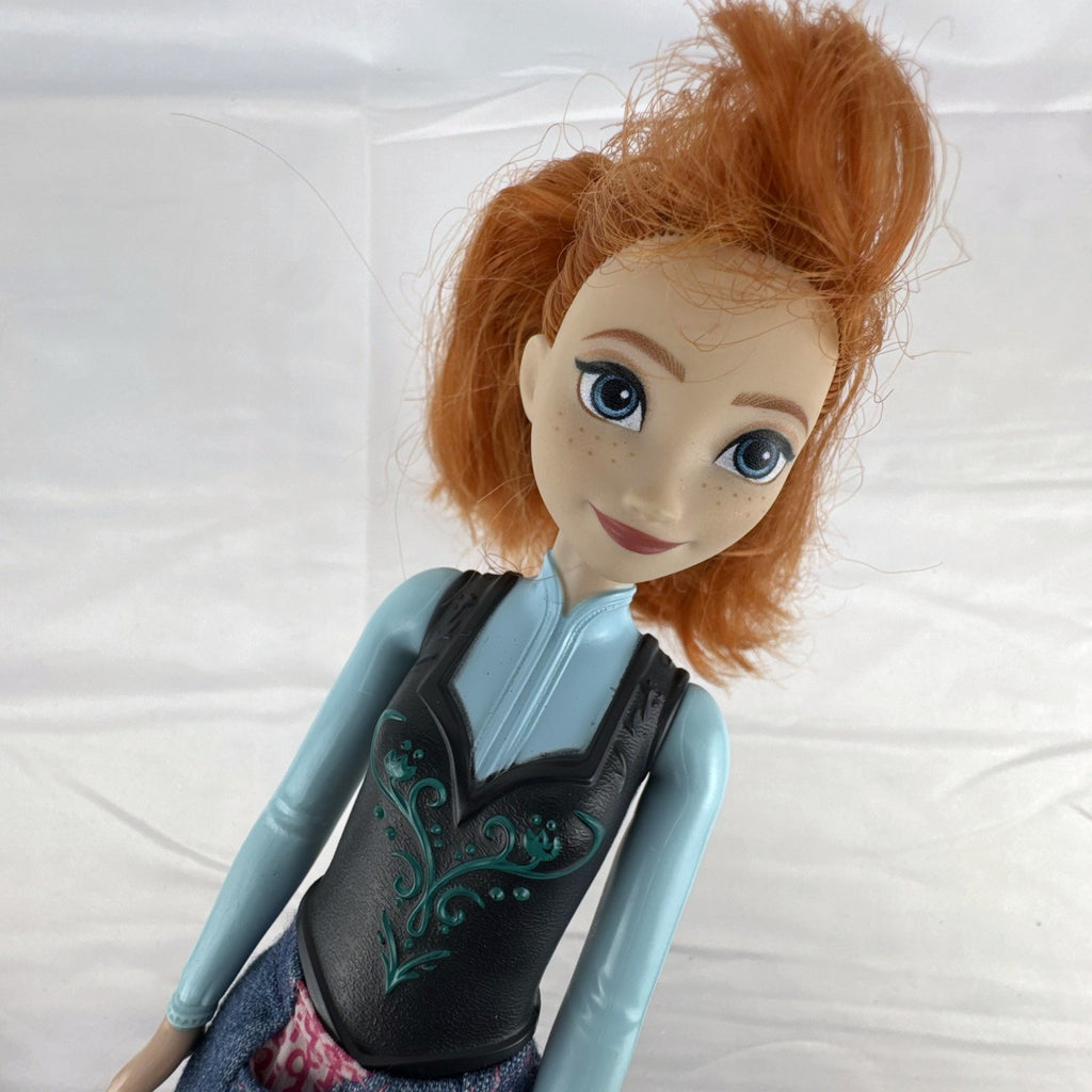Mattel Disney Frozen 11-inch Princess Anna doll with red hair, molded bodice, and denim skirt.
