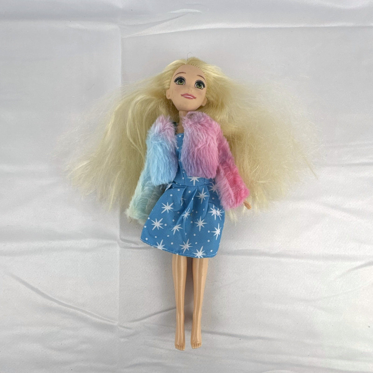 Disney Tangled Rapunzel 11-inch fashion doll wearing blue star dress and pastel faux fur jacket
