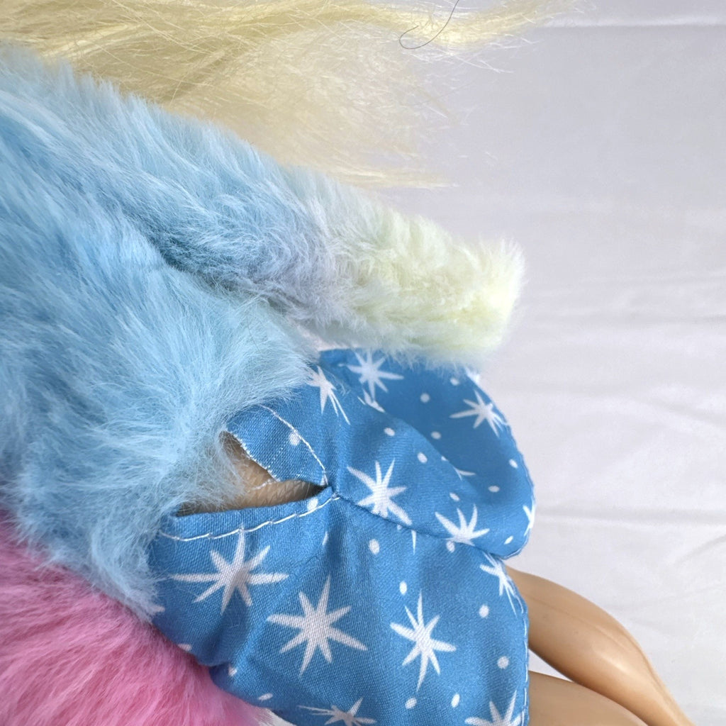 Disney Tangled Rapunzel 11-inch fashion doll wearing blue star dress and pastel faux fur jacket