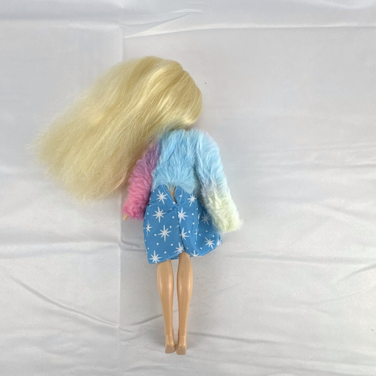 Disney Tangled Rapunzel 11-inch fashion doll wearing blue star dress and pastel faux fur jacket