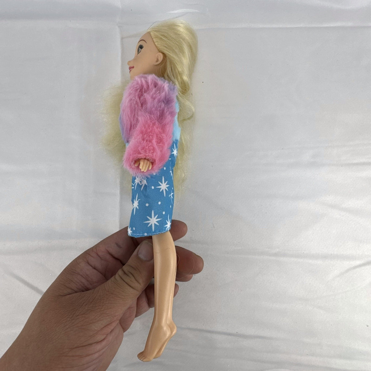 Disney Tangled Rapunzel 11-inch fashion doll wearing blue star dress and pastel faux fur jacket